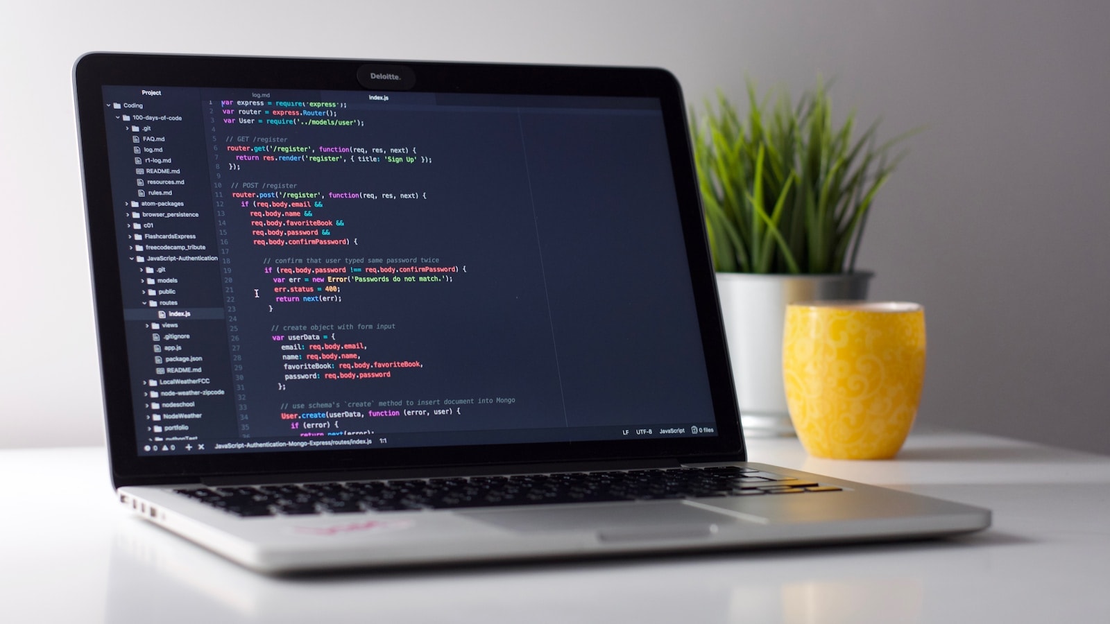 Laptop with code on a desk, ready for completed work